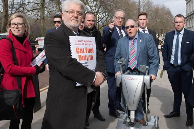 MP Robert Halfon (centre) and other Tory MPs along with members of haulage and transport associations outside The Treasury in Westminster, London, preparing to hand in a letter to Chancellor of the Exchequer Rishi Sunak urging him not to "balance environmentalism on the backs of working people". Photo: PA