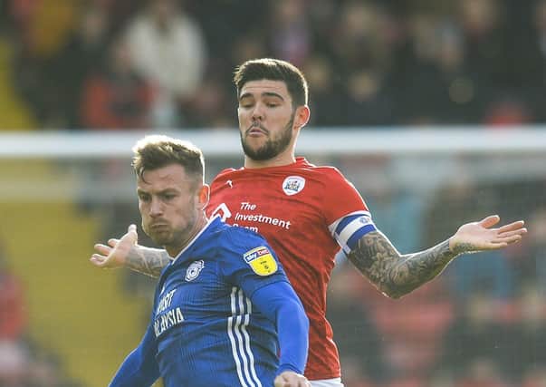 Fighting for the cause: Barnsley's Alex Mowatt up against Cardiff's Joe Ralls. Picture: Dean Atkins