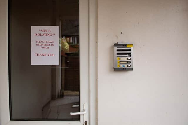 A stock photo of a self-isolation sign left outside a property, instructing where to leave deliveries, illustrating how self-isolating measures can be put in place.
