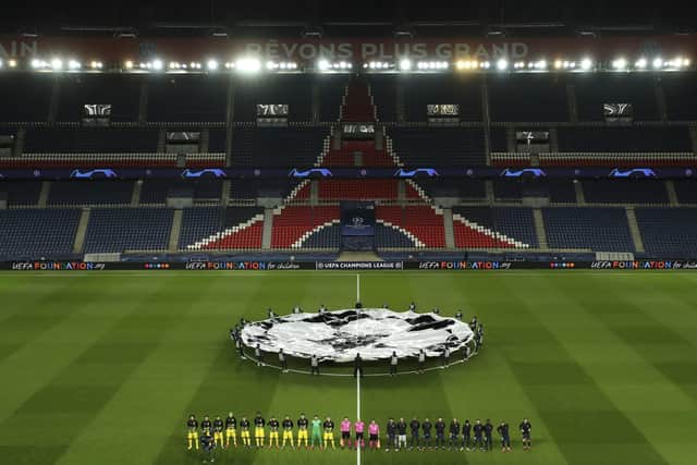 PSG and Borussia Dortmund players line up prior to their Champions League round of 16 second leg soccer match, Wednesday March 11, 2020 in Paris. The match is being played in an empty stadium because of the coronavirus outbreak. (UEFA via AP)