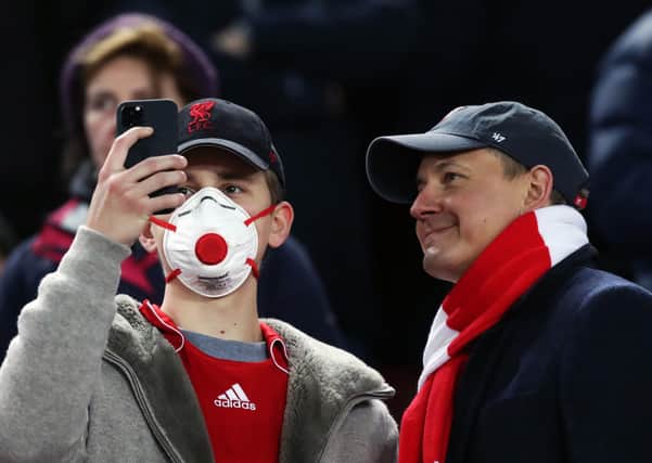 A Liverpool fan wearing a protective mask in the stands to prevent the spread of the coronavirus during the UEFA Champions League round of 16 second leg match at Anfield, Liverpool (PIcture: Peter Byrne/PA Wire)