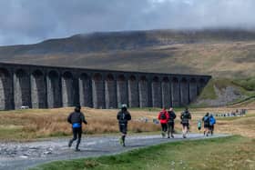 Three Peaks Race runners pass Ribblehead Viaduct