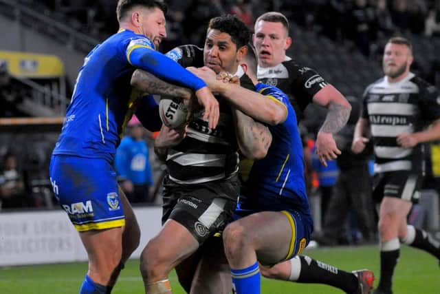 Hull FC's Albert Kelly is tackled by the Warrington defence. (PIC: STEVE RIDING)