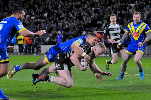 Hull FC's Josh Bowden is floored by Warrington's Anthony Gelling in Thursday night's defeat. Picture: Steve Riding.