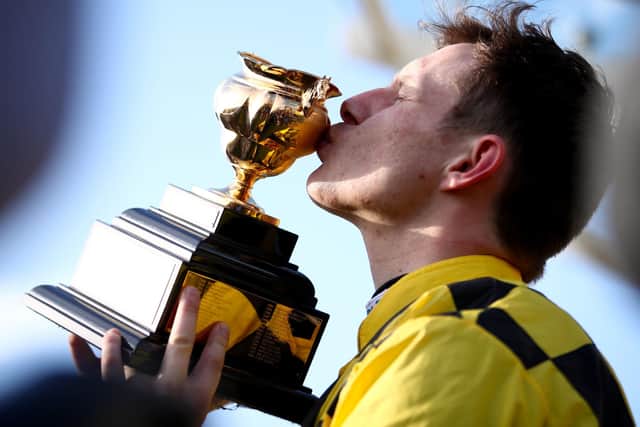 Jockey Paul Townend holds up the trophy after winning the Magners Cheltenham Gold Cup Chase with Al Boum Photo.