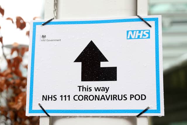 A sign directs patients towards an NHS 111 Coronavirus (COVID-19) Pod, where people who believe they may be suffering from the virus can attend and speak to doctors.