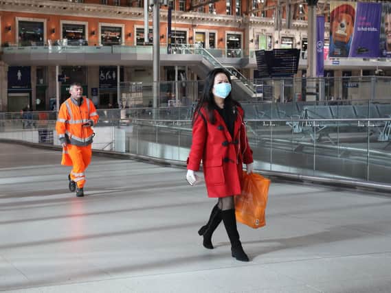 A commuter wearing a face mask at Waterloo station in London, as the UK's coronavirus death toll rose to 35. Picture: PA Wire