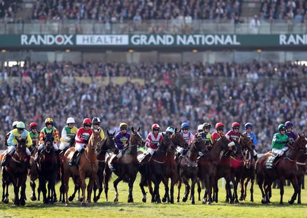 Off:  Runners and riders at the start of the Randox Health Grand National. Picture: David Davies/PA