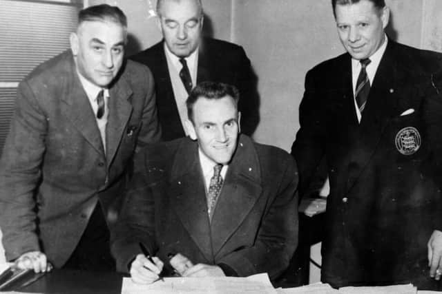 Don Review signs his contract to become Leeds United manager in 1961.