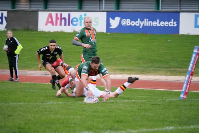 AJ Boardman scores for Hunslet against Bradford Bulls. Lower division teams will also be hit by rugby league's shutdown. Picture by Paul Johnson.