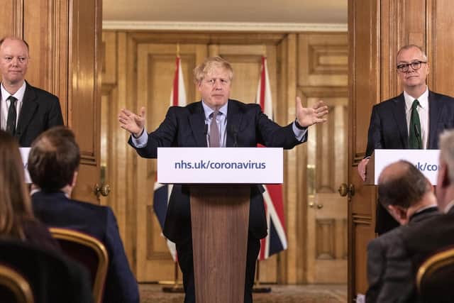 Chief Medical Officer for England Chris Whitty (left) and Chief Scientific Adviser Sir Patrick Vallance stand with Prime Minister Boris Johnson during a media briefing in Downing Street on Monday, where the new measures were announced. Picture: Richard Pohle/The Times /PA Wire