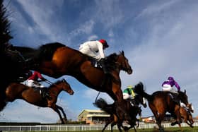 Cnoc Sion ridden by jockey David Noonan (red hat) clear a fence during the Central Roofing Handicap Chase at Hereford Racecourse on Monday. Picture: David Davies/PA