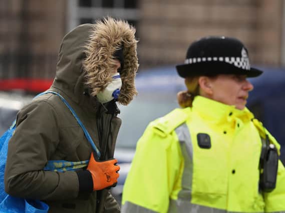 A man wears a face mask on the Royal Mile in Edinburgh