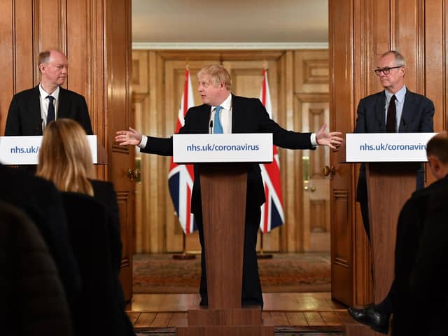 Chief Medical Officer Professor Chris Whitty (left) and Chief Scientific Adviser Patrick Vallance (right) watch as Prime Minister Boris Johnson gestures as he speaks during a coronavirus news conference inside 10 Downing Street. Photo: Leon Neal/PA Wire