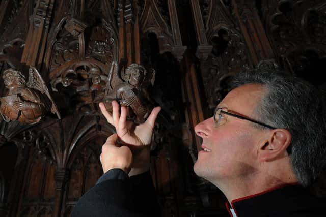The Dean of Ripon, the Very Rev John Dobson, returned the fallen angel to its position within the cathedral quire. Image: Simon Hulme