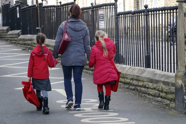 Children leaving a school in Leeds following the Government announcement that all schools in England will close.
