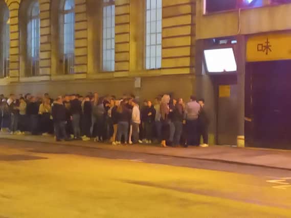 People queuing to get into The Acapulco Club on Friday during the coronavirus crisis. Photo taken by Rebecca Caswell.