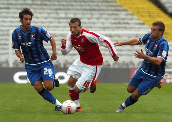 Rotherham United's Adam Le Fondre, races up the field away from Cheltenham's Frankie Artus and Michael Pook back in 2010.