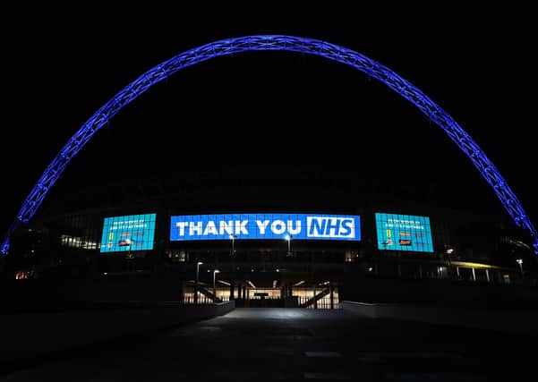 Wembley Arch is illuminated in blue to show its appreciation to the NHS amid the coronavirus outbreak in London, after Prime Minister Boris Johnson ordered pubs and restaurants across the country to close tonight as the Government announced unprecedented measures to cover the wages of workers who would otherwise lose their jobs due to the coronavirus outbreak.
