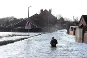 Stuart Smith, a volunteer from Somerset standing in the floodwaters of East Cowick, Yorkshire. Pic: Peter Byrne/PA