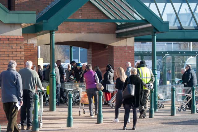 There are still queues outside supermarkets - despite appeals to people to stop panic buying.