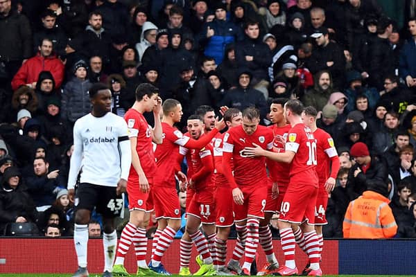 Barnsley's  Cauley Woodrow (centre) celebrates scoring from the penalty spot against Fulham at Craven Cottage. Picture: Victoria Jones/PA