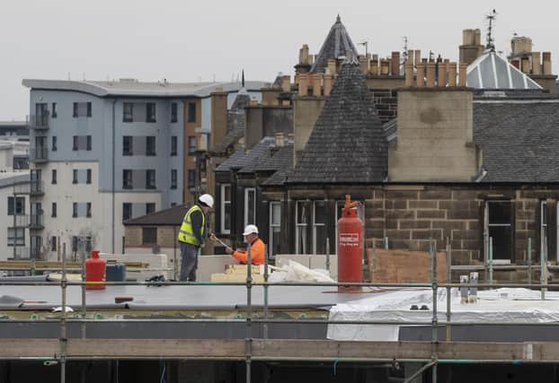 Construction workers in Edinburgh the day after Prime Minister Boris Johnson put the UK in lockdown to help curb the spread of the coronavirus. Picture: Jane Barlow/PA Wire
