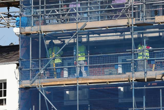 Construction workers at the Waterside Quarter development site in Maidenhead, Berkshire, the day after Prime Minister Boris Johnson put the UK in lockdown to help curb the spread of the coronavirus. Picture: Jonathan Brady/PA Wire