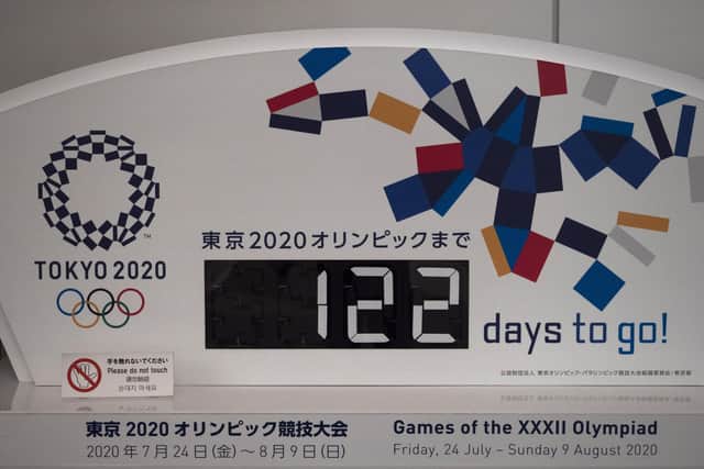 A countdown display for the Tokyo 2020 Olympics is photographed in Tokyo, Tuesday, March 24, 2020. IOC President Thomas Bach has agreed "100%" to a proposal of postponing the Tokyo Olympics for about one year until 2021 because of the coronavirus outbreak, Japanese Prime Minister Shinzo Abe said Tuesday. (AP Photo/Jae C. Hong)