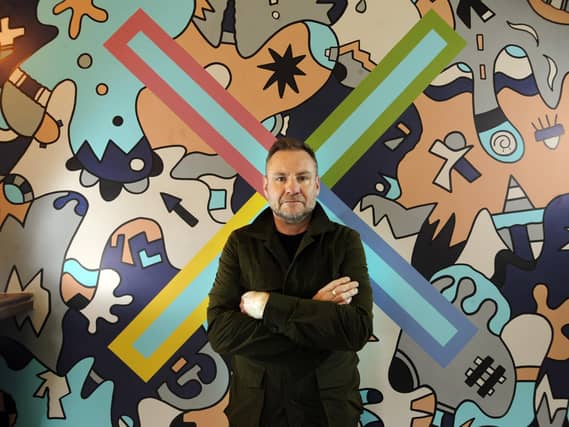 Nicolas Dixon with his mural at the Foundry Restaurant, Leeds. Picture by Simon Hulme