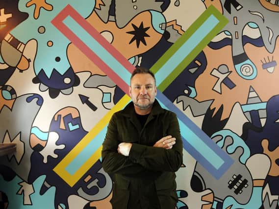 Nicolas Dixon with his mural at the Foundry Restaurant, Leeds. Picture by Simon Hulme