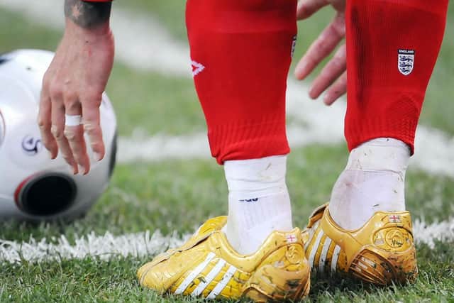 golden boots: England's David Beckham wears golden boots to mark his 100th cap.