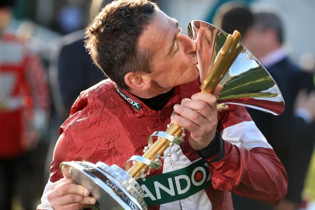 Davy Russell celebrates Tiger Roll's second Grand National win.