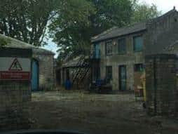 The outbuildings which will be transformed into flats