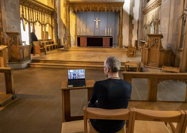 A church parishioner watches a laptop inside Liverpool Parish Church (Our Lady and St Nicholas) in Liverpool, during the Church of England's first virtual Sunday service given by the Archbishop of Canterbury Justin Welby, after the archbishops of Canterbury and York wrote to clergy on Tuesday advising them to put public services on hold in response to Government advice to avoid mass gatherings to help prevent the spread of the Covid-19 virus.