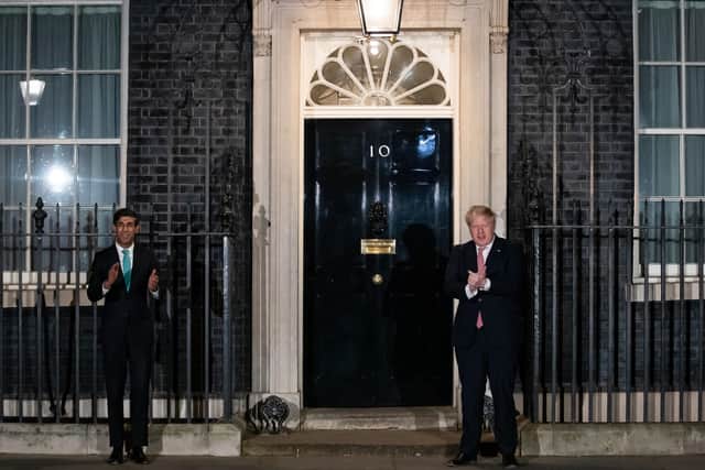 Prime Minister Boris Johnson (right) and Chancellor Rishi Sunak outside 10 Downing Street, London, joining in with a national applause for the NHS to show appreciation for all NHS workers.