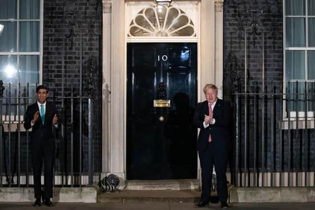 Prime Minister Boris Johnson (right) and Chancellor Rishi Sunak outside 10 Downing Street, London, joining in with a national applause for the NHS to show appreciation for all NHS workers who are helping to fight the Coronavirus.