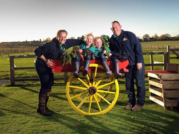 Family owned Bert's Barrow has become a drive-thru farm shop. Pictured are Charlotte Wells Thompson and Jason Thompson with their daughters Hattie and Tilly