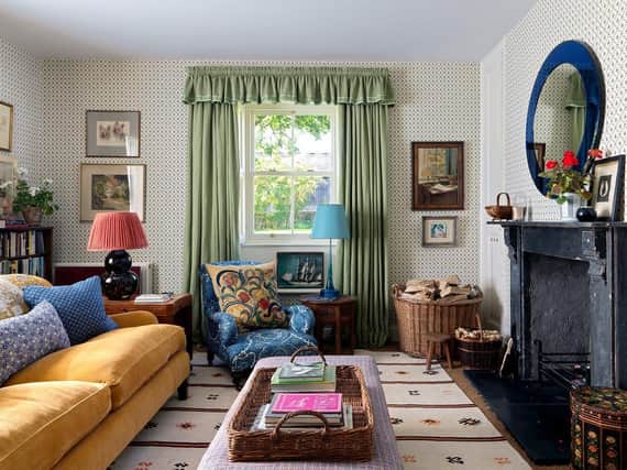 Mixing colours, pattern and styles like this shows true skill. The yellow sofa was designed by Rita's mother, Nina Campbell. The curtains are a Claremont twill with Nina Campbell braided trim.