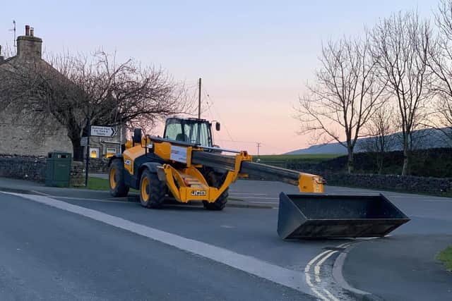 The JCB blocking the car park of the Crown Hotel in Horton-in-Ribbledale. Credit: Sharon Millman.
