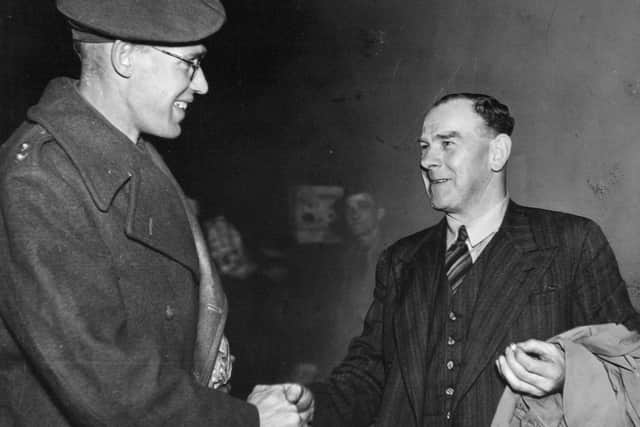 Back home: 
Bill Bowes being greeted by Jim Wright, an old Bingley friend, on his arrival in Leeds after nearly three years as a prisoner of war.