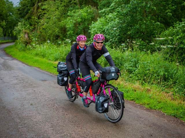 Catherine Dixon and Rachael Marsden who have broken the male record cycling around the world on a tandem called Alice. Credit: Oxfam