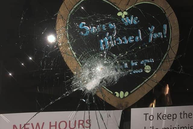 Some of the damage to the shop's windows