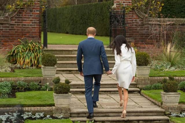 Harry and Meghan walk away. Picture: Dominic Lipinski/PA Wire