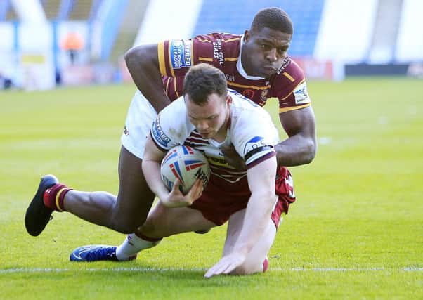 IMPACT: Huddersfield's Jermaine McGillvary  tackles Wigan's Liam Marshall earlier this year. Picture: Chris Mangnall/SWpix.com