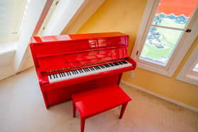 A red lacquer Young Chang upright piano (est 1,600-3,200) part of the film memorabilia, artwork and jewellery belonging to the late Hollywood star Doris Day which are set to go under the hammer. Juliens Auction/PA Wire