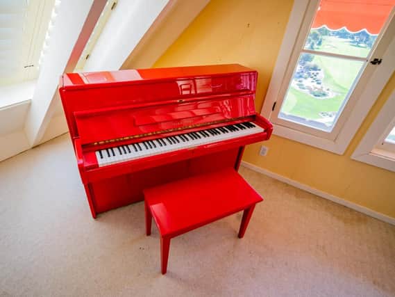 A red lacquer Young Chang upright piano (est 1,600-3,200) part of the film memorabilia, artwork and jewellery belonging to the late Hollywood star Doris Day which are set to go under the hammer. Juliens Auction/PA Wire