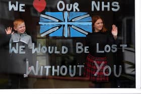 Lydia Hardwick aged 11 with her brother Daniel aged 8, support the NHS by painting their window through the Coronavirus outbrea, at Oulton, Leeds. Picture by Simon Hulme