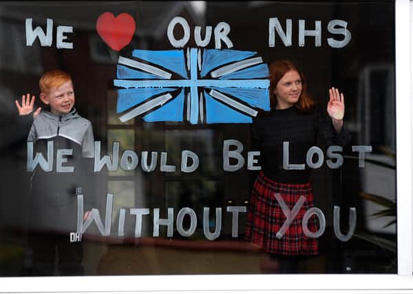 Lydia Hardwick aged 11 with her brother Daniel aged 8, support the NHS by painting their window through the Coronavirus outbrea, at Oulton, Leeds. Picture by Simon Hulme