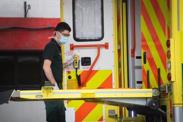 A paramedic escorts a patient arriving at St Thomas' Hospital in Westminster, London as the UK continues in lockdown to help curb the spread of the coronavirus. Photo: PA